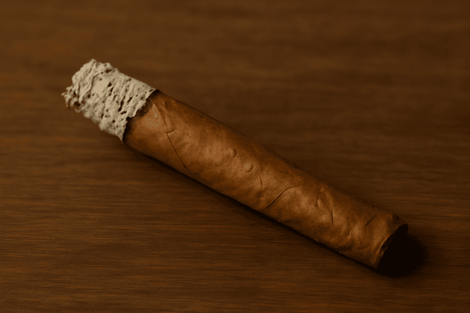 A rolled blunt burning to a clean white ash